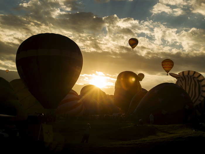 Tourists and locals alike flock to the 360-acre balloon park to watch the morning ascension at daybreak.