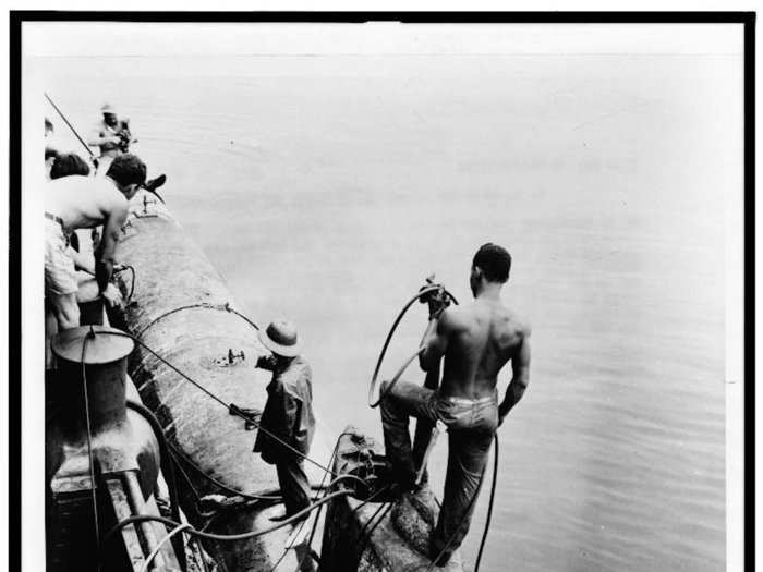 Sailors at Pearl Harbor worked to salvage their ships and restore the base. This picture shows the recovery of a Japanese midget submarine abandoned during the Pearl Harbor attack.