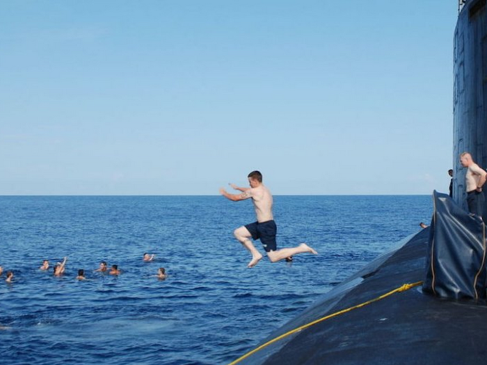 The US Navy submarine force consists of four vessel classes, all of which are nuclear-powered. In this 2004 photo, the crew of the USS Portsmouth enjoy the waters of the Pacific Ocean while deployed.