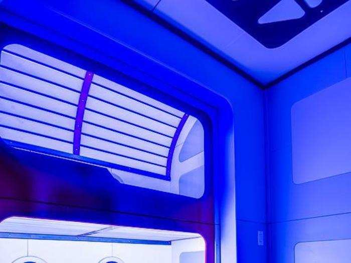 Blue lighting brings the sci-fi experience home, especially in the pod-style bunk beds.