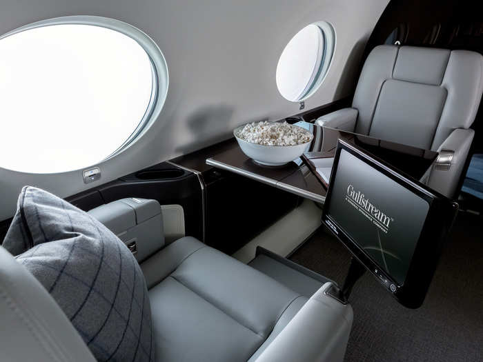 The cabin features tables abound along with 12 portholes that let in as much light as possible. Gulfstream actually advertises the jet as being bright and airy.