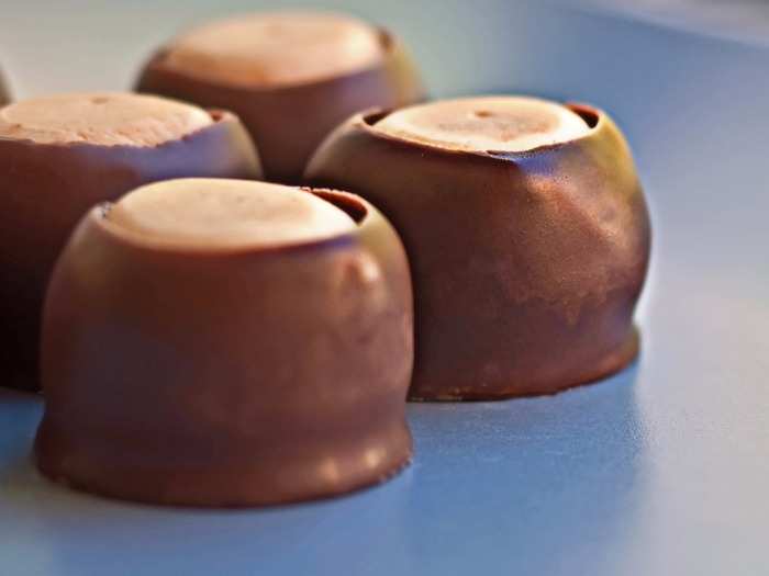 OHIO: For those who have a sweet tooth, go for buckeyes—peanut butter fudge pieces that are partially-dipped in chocolate to resemble the nut of the Ohio buckeye tree.