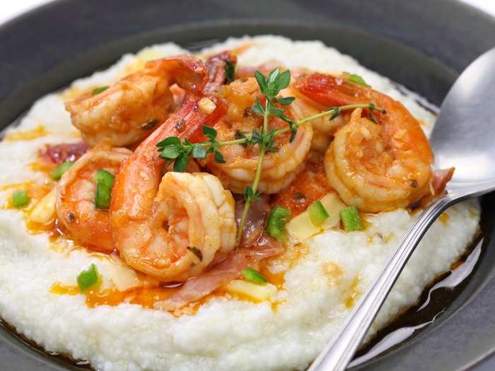 SOUTH CAROLINA: Shrimp and Grits—fresh shrimp served on a bed of simmered milled corn—is a classic dish in South Carolina. Mix-ins can include everything from bacon, garlic, and lemon to mushroom and scallions.