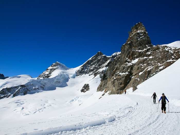 Go skiing, hiking, or canyoning in Interlaken, Switzerland, which is known for its outdoor adventure activities.