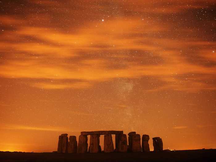 Watch the sun set at Stonehenge, in southern England.