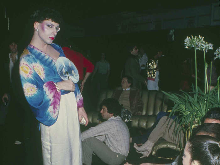 This brightly attired patron used a fan to cool off in the club’s lounge area in 1979.