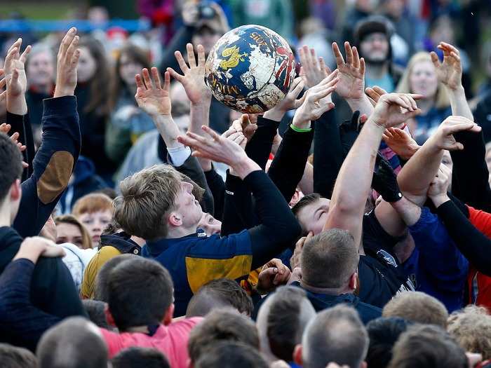 The annual Shrovetide football match in Ashbourne, central England, consists of teams — the Up