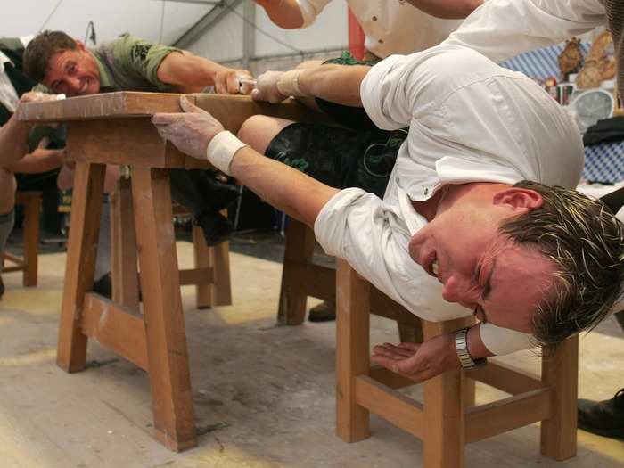 Fingerhakln is the name given to a traditional finger-pulling competition played in Germany. Two opponents sitting across from each other at a table hook their middle fingers into a leather ribbon and pull the other over the table