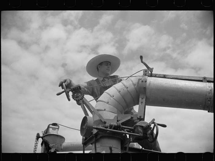 A clover farmer works on a seed threshing machine in St. Charles Parish, Louisiana.