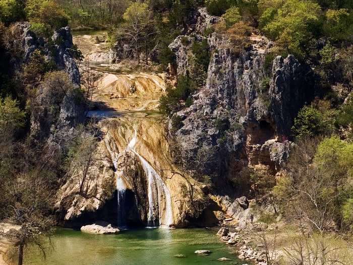 OKLAHOMA: Turner Falls Park is located within the Arbuckle Mountains in Oklahoma and offers a bunch of outdoor activities. See the 77-foot waterfall, swim in the mountain water, and make sure to visit the abandoned Collings Castle.