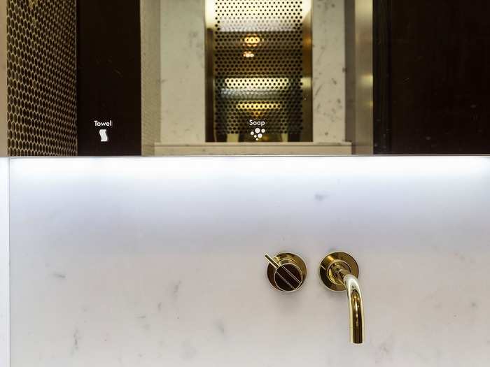 The washroom and toilets walls are lined in floor to ceiling “gold” mosaic.