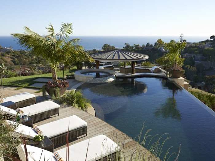 Out back, an infinity pool with swim-up bar also overlooks the ocean.