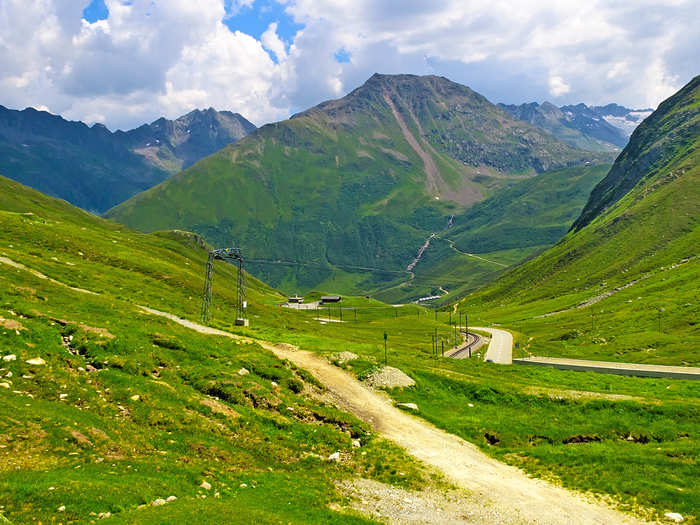 The Oberalp Pass in Switzerland winds through the Swiss Alps and is 6,706 feet above sea level. The road is only open during the summer, but in the winter you can take a train ride across the pass.