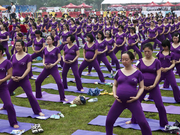 This group of expecting moms practice yoga as they attempt to break the Guinness World Record for the largest prenatal yoga class. The current record is 553 participants.