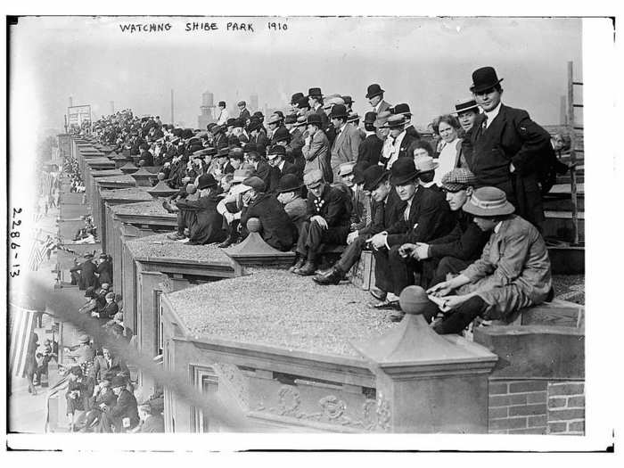 Fans watching from the rooftops outside Shibe Park.