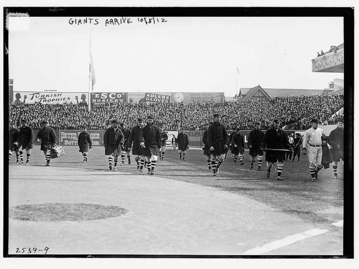 Giants players walking onto the field at the Polo Grounds.