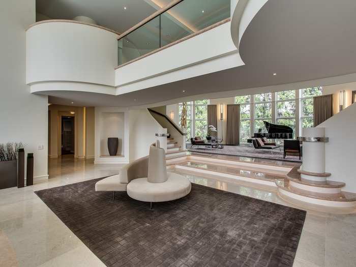 A huge sculptural balcony overlooks the huge foyer.