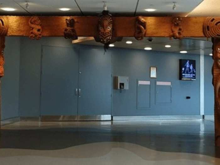 As First Class passengers, we were the first ones to get out of the plane.

Auckland to Sydney: The first thing that greeted me was this New Zealand themed woodwork. Nothing like a couple of scary faces to welcome you to New Zealand!