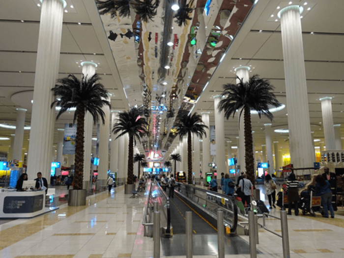 Dubai to Milan: The baggage claim area itself was a bit surreal, with a walkway flanked by palm trees on both sides.