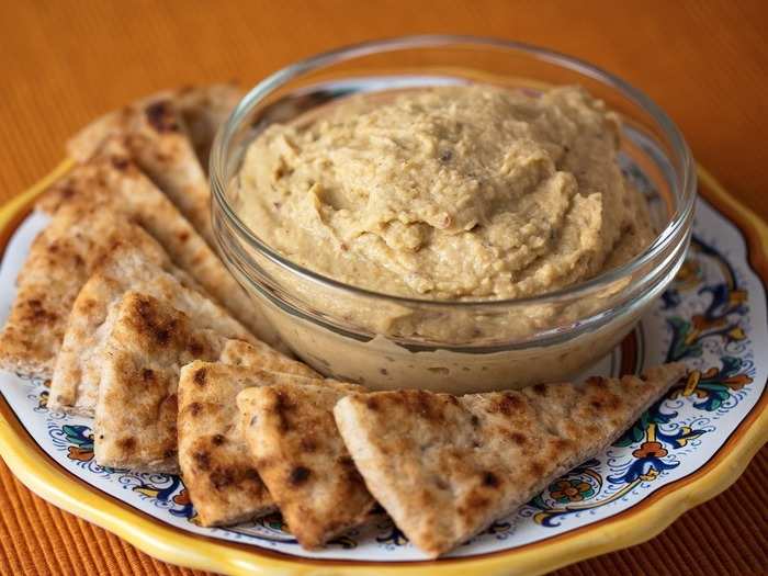 Hummus and whole grain pita, string cheese, grapes, and cherry tomatoes