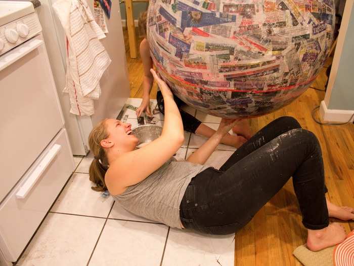 Applying the papier maché to the bottom half was a bit trickier. My roommates helped me string the balloon from our ceiling using dental floss, which worked surprisingly well.