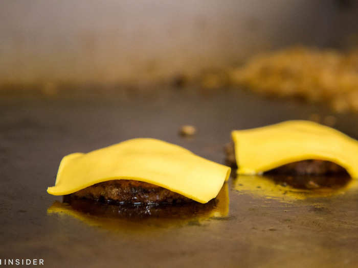 Slices of cheese folded at the corners as they melted on top of the patties. Serritella called this the "dog-ear approach," and said not many chains melt cheese before assembly.