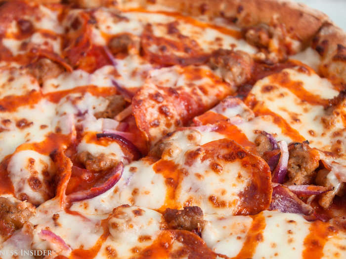 The pizza is covered with meat, which luckily is identifiable: pepperoni and Italian sausage. It