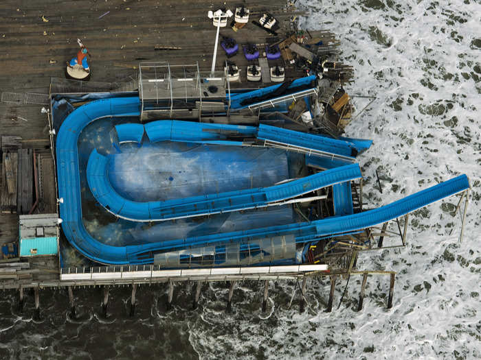 A water slide hangs over the end of an amusement park