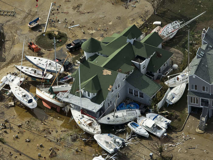 Boats that have washed ashore are seen piled next to a house near Monmouth Beach, New Jersey.