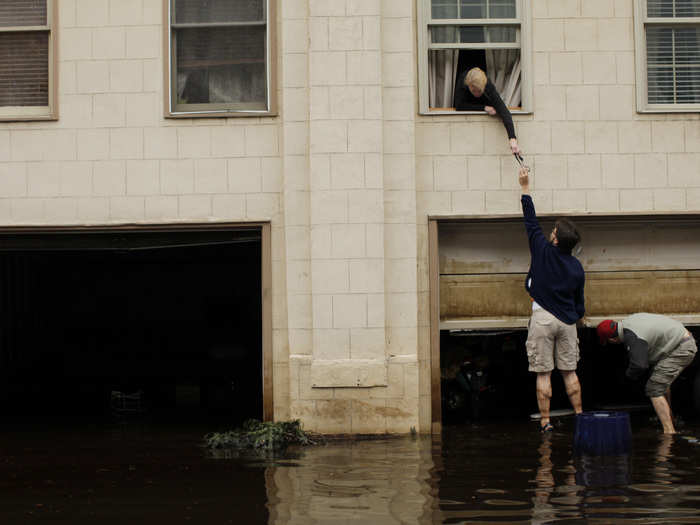 In Hoboken, New Jersey, people try to open their garage despite the floodwaters.