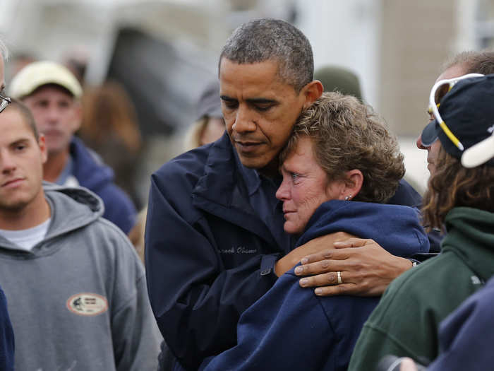 President Obama hugs the owner of the North Point Marina as he tours damaged areas in Brigantine, New Jersey.