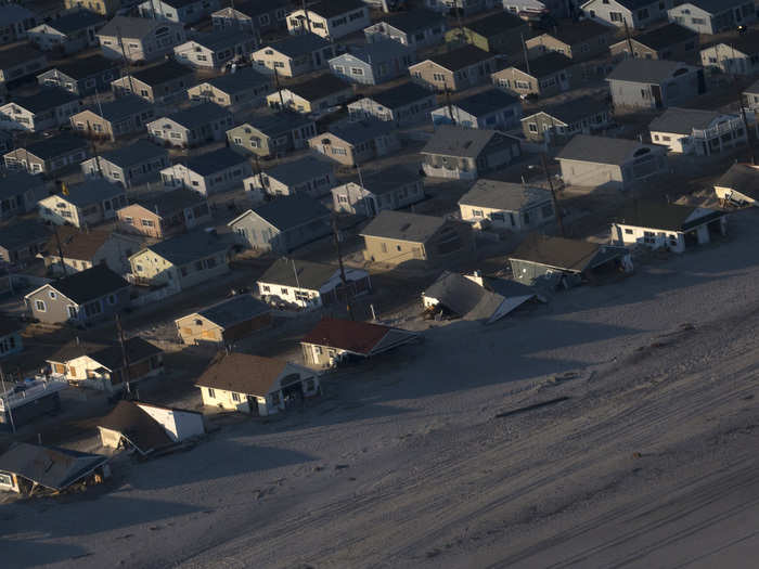 Houses are surrounded by sand near Ortley Beach, New Jersey, almost a month after the area was hit by Hurricane Sandy.