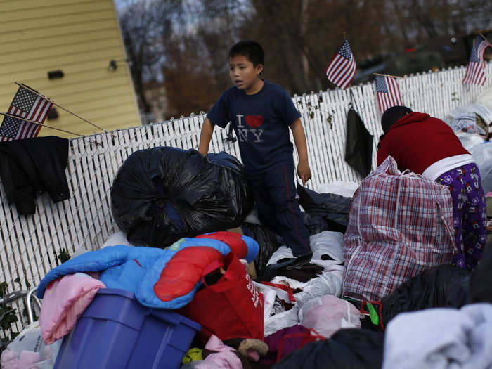 On the south side of Staten Island, a young boy and his mother search through piles of clothes donated to victims of Hurricane Sandy.