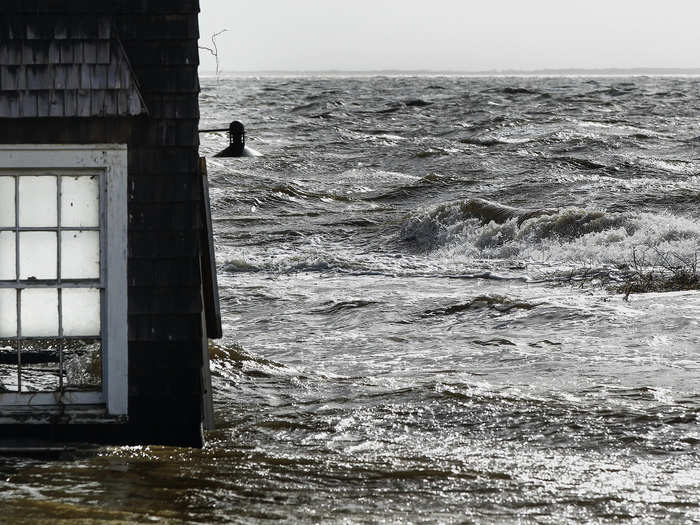 Also in Bellport, forces from the hurricane push water into the window of a building.