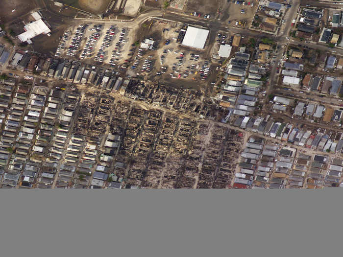 An aerial view of the burnt houses, surrounded by houses that survived, in Breezy Point.