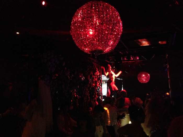 Performers decked out in shiny costumes could be seen scaling the sides of the dance floor.