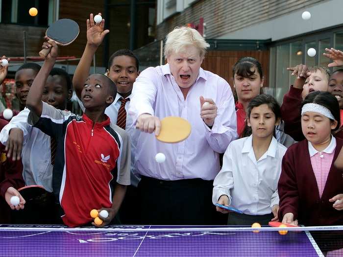 Johnson plays ping pong with London students in June 2010. The event was part of a summertime program of free sporting events to encourage Londoners to be more active.