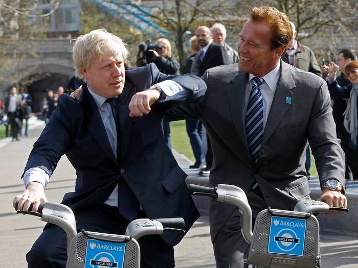 He poses with Arnold Schwarzenegger while riding bikes through London.