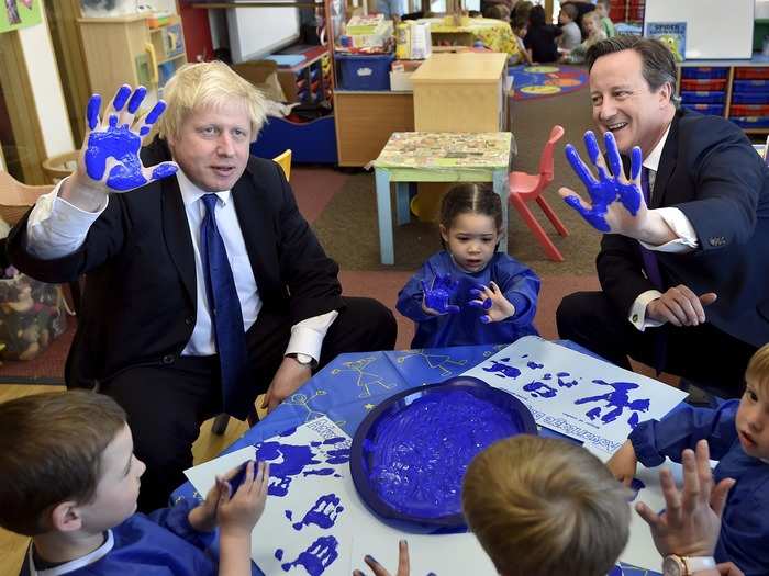 Johnson and Cameron show off their blue hands at a daycare in Surbiton.