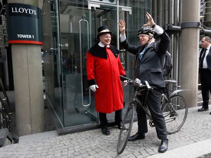 Johnson gets ready to ride away on his bike after addressing employees at Lloyd