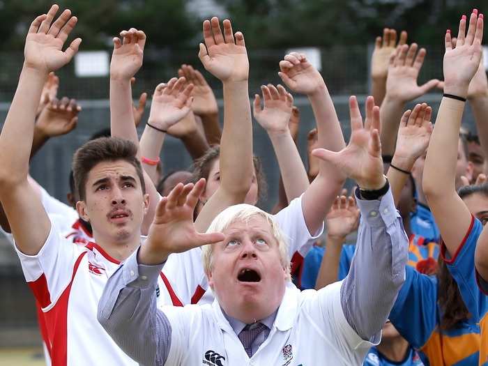 He jumps for the ball during a rugby training session at Haverstock School in London.