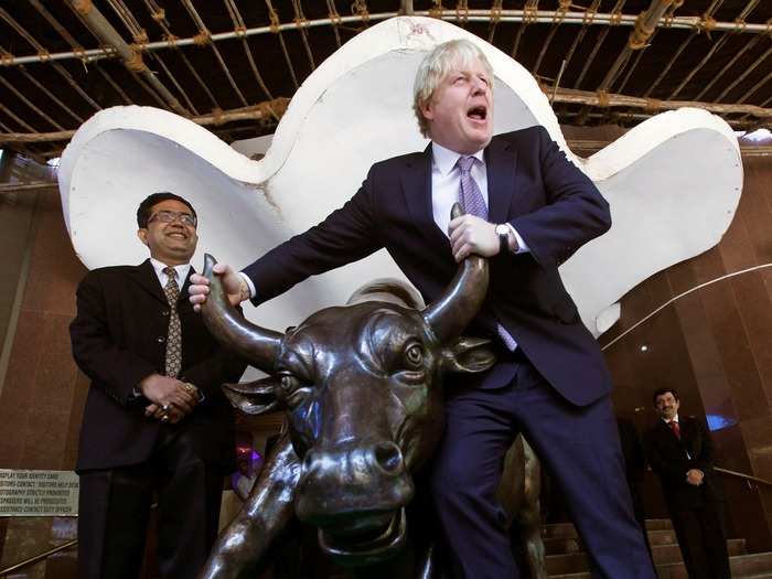 Johnson poses with a bronze bull statue outside the Bombay Stock Exchange in Mumbai, India, in 2012. He was in India to promote London as a destination for investors and international trade.