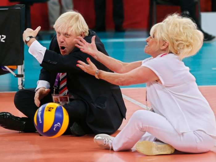 He gets competitive while playing sitting volleyball with British actress Barbara Windsor during the 2012 Paralympic Games.