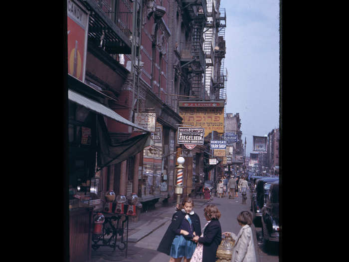 Three girls talk outside a candy shop in Lower Manhattan.