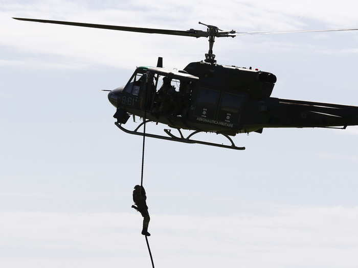 The starting ceremony featured displays of military prowess, like Italian soldiers rappelling out of helicopters ...