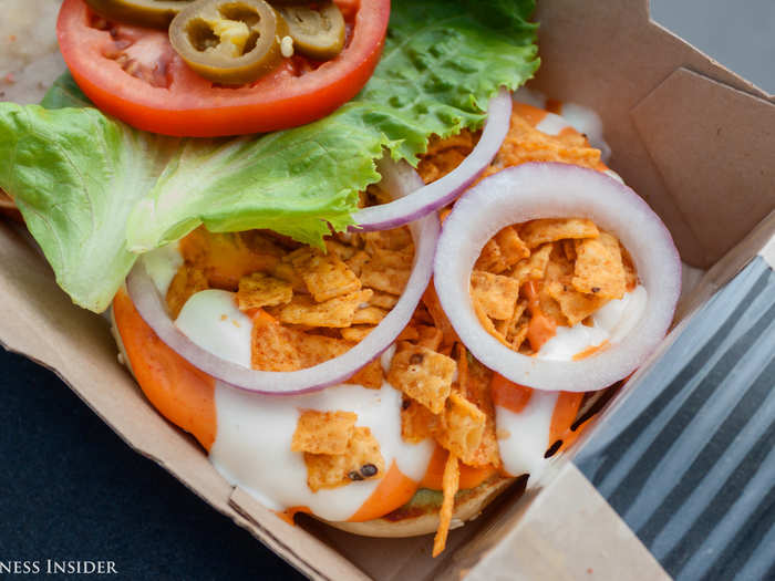 Guacamole, spicy Sriracha mayo, creamy garlic sauce, chili-lime tortilla strips, and crisp red-onion slices are all stacked into this burger, bookended by a premium bun with sesame seeds. That looks like a lot of sauce, but I