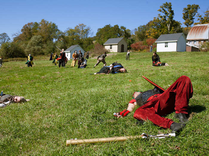 After the battle, some players lay "dead" on the field. Others catch their breath and regroup about the events that have just taken place. Combat can be rigorous and not everyone is in peak physical condition.