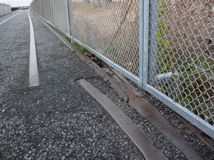 Parts of the park path are paved around the railways. You can see the original turn-switch for the train in this gap under the fence.