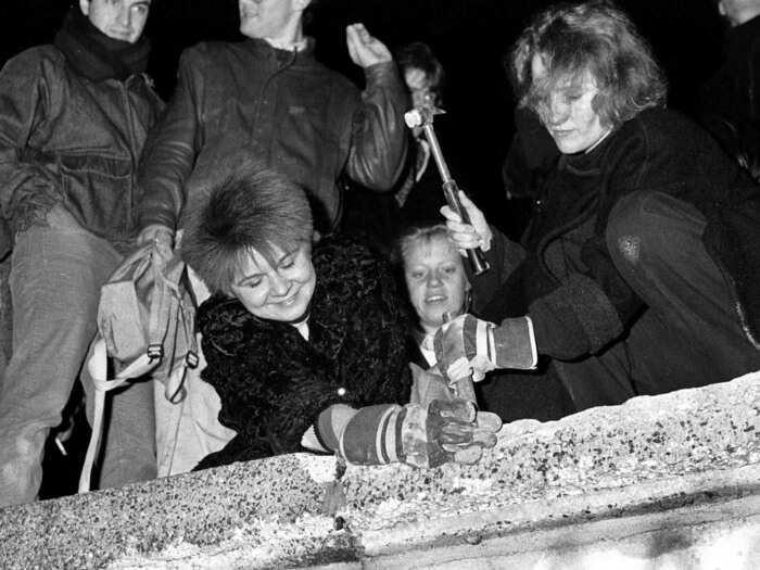 Berliners carried hammers and chisels to begin chipping away at the wall.