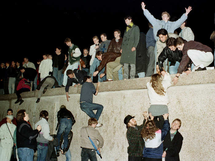 East Germans celebrated as they climbed the Berlin Wall at the Brandenburg Gate